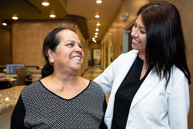 patient and doctor smiling together after patient's dental treatment